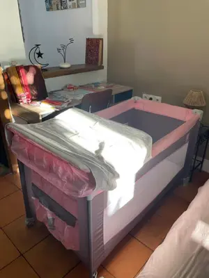 a bed in a room with a table at Du côté de chez nous in Cuxac-dʼAude