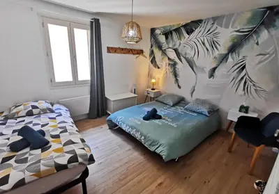 a bedroom with a bed and a large mural at Les remparts de Caroline, au pied de La Cité. in Carcassonne