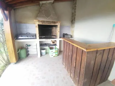 a kitchen with a stove and a stove top oven at Le joyaux d'ambre in La Pomarède
