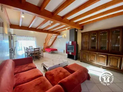 a living room with a couch and a dining room at Le joyaux d'ambre in La Pomarède
