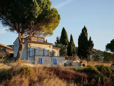 an old stone house in a field with a tree at Domaine de Roquenégade - Piscine, sauna et bain nordique in Pradelles-en-Val
