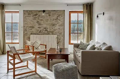 a living room with a couch and a table at Domaine de Roquenégade - Piscine, sauna et bain nordique in Pradelles-en-Val
