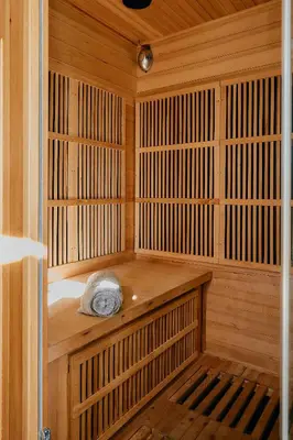 a wooden sauna with a towel sitting in it at Domaine de Roquenégade - Piscine, sauna et bain nordique in Pradelles-en-Val