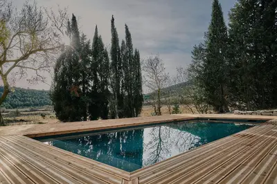 a swimming pool on the roof of a house at Domaine de Roquenégade - Piscine, sauna et bain nordique in Pradelles-en-Val