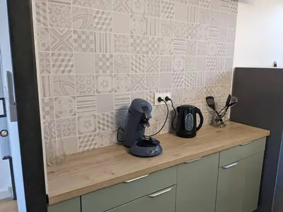 a kitchen counter with a mixer and appliances on it at Appartment - vue imprenable sur la cité médiévale - Parking gratuit - Climatisé in Carcassonne