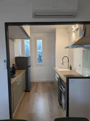 a kitchen with a sink and a counter top at Appartment - vue imprenable sur la cité médiévale - Parking gratuit - Climatisé in Carcassonne