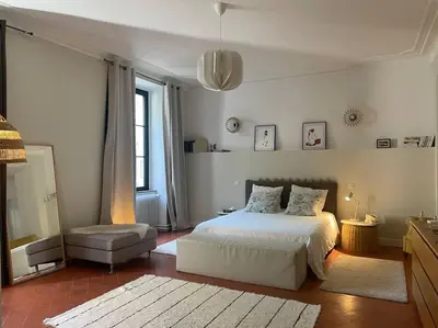 a bedroom with a bed and a chair in it at Grande Maison de Maitre contemporaine à 10 min de la mer et Piscine in Salles-d'Aude