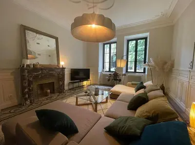 a living room with a couch and a fireplace at Grande Maison de Maitre contemporaine à 10 min de la mer et Piscine in Salles-d'Aude