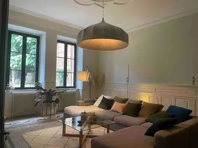 a living room with a couch and a table at Grande Maison de Maitre contemporaine à 10 min de la mer et Piscine in Salles-d'Aude