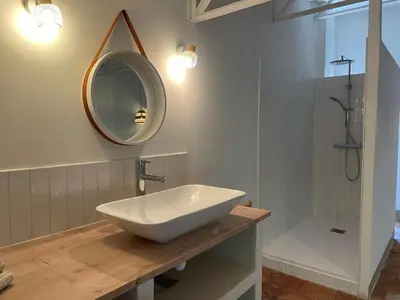 a bathroom with a sink and a mirror and a shower at Grande Maison de Maitre contemporaine à 10 min de la mer et Piscine in Salles-d'Aude