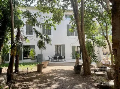 a large white building with trees in front of it at Grande Maison de Maitre contemporaine à 10 min de la mer et Piscine in Salles-d'Aude