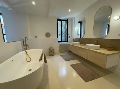 a bathroom with a tub and two sinks and a mirror at Grande Maison de Maitre contemporaine à 10 min de la mer et Piscine in Salles-d'Aude