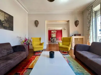a living room with two couches and yellow chairs at Le Balcon de Gambetta ※ in Carcassonne