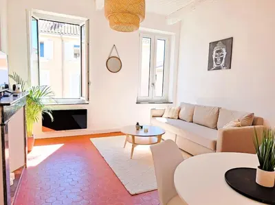 a living room with a couch and a table at Appartement à 100m des Barques in Narbonne