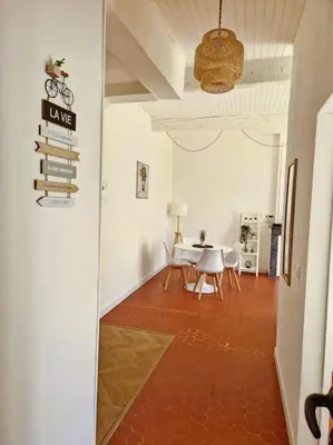 a living room with a table and chairs at Appartement à 100m des Barques in Narbonne
