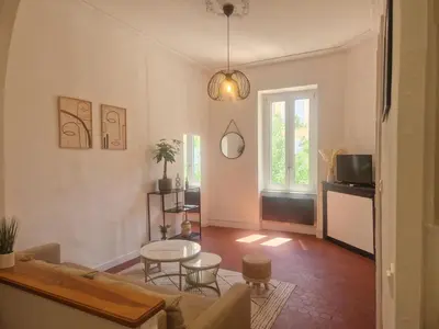 a living room with a couch and a table at Appartement à 100m des Barques in Narbonne