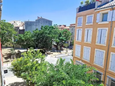 an overhead view of a street in a city with buildings at Appartement à 100m des Barques in Narbonne