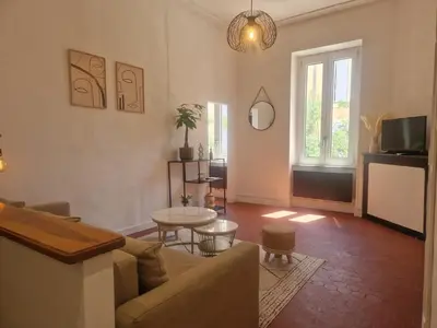 a living room with a couch and a table at Appartement à 100m des Barques in Narbonne
