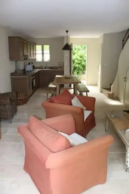 a living room with two couches and a kitchen at Maison provençale en Corbières in Saint-Laurent-de-la-Cabrerisse