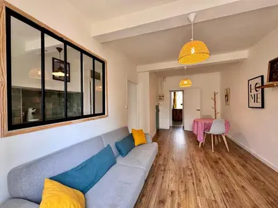 a living room with a couch and a table at Appartement Minervoise - Gare Carcassonne in Carcassonne
