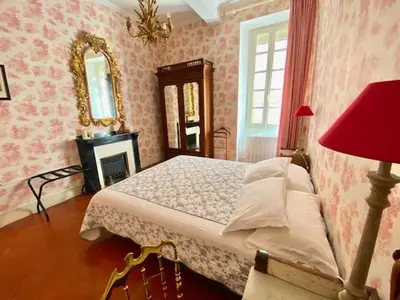 a room with a wooden desk and a table with chairs at Maison Ville-Limoux in Limoux