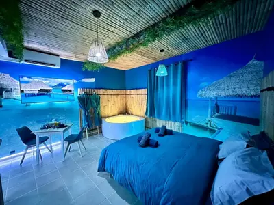 a bedroom with a bed and a swimming pool at BORA-BORA SUITE - Jacuzzi - Centre by Narbana in Narbonne