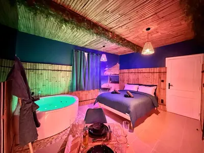 a bedroom with a bed and a bath tub at BORA-BORA SUITE - Jacuzzi - Centre by Narbana in Narbonne