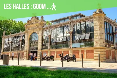 a building with motorcycles parked in front of it at BORA-BORA SUITE - Jacuzzi - Centre by Narbana in Narbonne