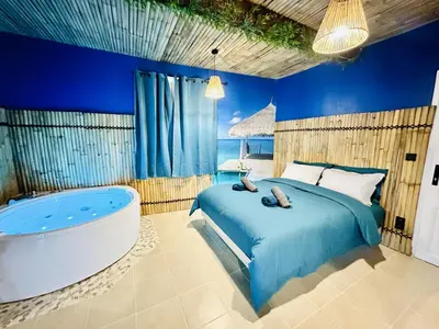 a bedroom with a bed and a bath tub at BORA-BORA SUITE - Jacuzzi - Centre by Narbana in Narbonne
