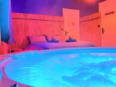 a room with two beds and a swimming pool at BORA-BORA SUITE - Jacuzzi - Centre by Narbana in Narbonne