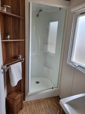 a shower with a glass door in a bathroom at Anthony MH 140 in Port-la-Nouvelle