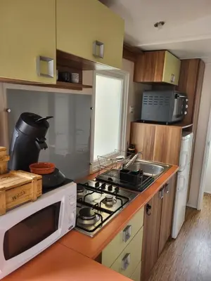 a kitchen with a microwave and a stove top oven at Anthony MH 140 in Port-la-Nouvelle