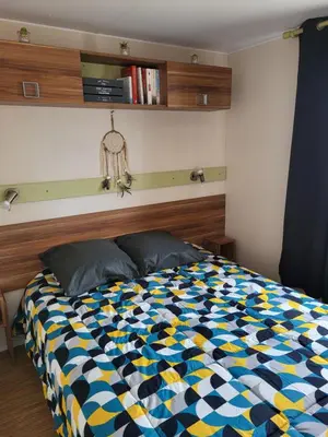 a bedroom with a bed with a colorful comforter at Anthony MH 140 in Port-la-Nouvelle