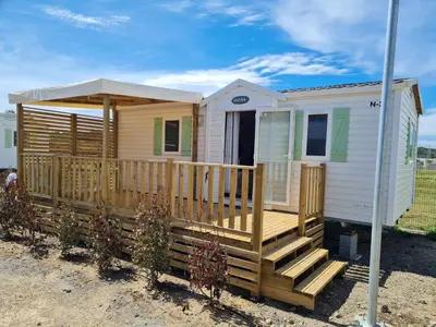 a tiny house with a porch and a deck at Anthony MH 140 in Port-la-Nouvelle