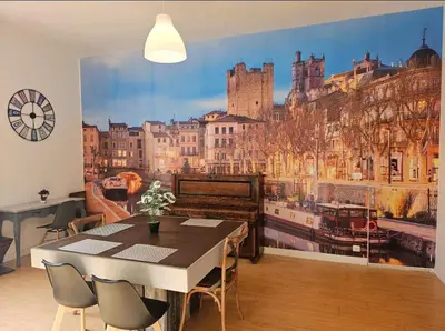 a dining room with a large mural of a city at Appartement Morgand in Narbonne