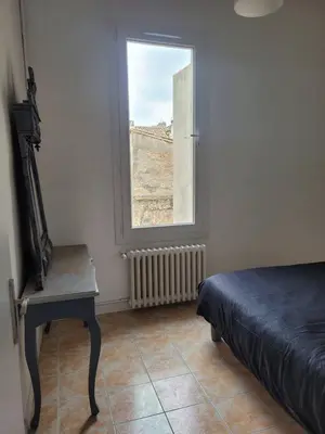 a bedroom with a bed and a window at Appartement Morgand in Narbonne