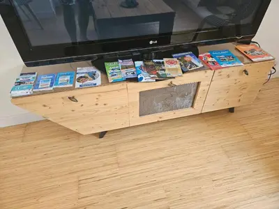 a table with books and a tv on top at Appartement Morgand in Narbonne