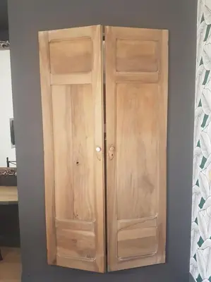 a wooden cabinet with two doors in a room at Le Merlane - A 2 pas de la Cité & du centre ville in Carcassonne