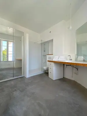 a white bathroom with a sink and a toilet at Maison d’hôtes Le 1853 in Narbonne