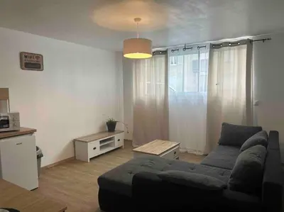 a living room with a couch and a table at Appartement proche centre ville in Castres