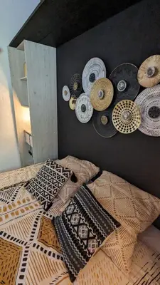 a bedroom with a bed with many hats on the wall at Grande maison Carpediem, le calme à la campagne in Cassaignes
