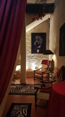 a living room with a couch and a table at La Demeure du Pressoir in Cuxac-dʼAude