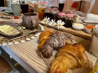 a table with pastries and croissants on a table at La Demeure du Pressoir in Cuxac-dʼAude