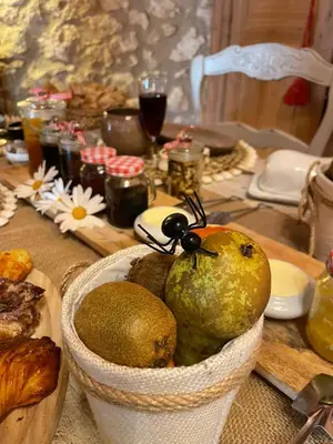 a table with a basket of fruit on a table at La Demeure du Pressoir in Cuxac-dʼAude