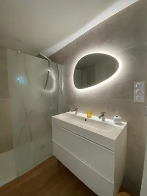 a bathroom with a white sink and a mirror at La Maison de Jeanne in Narbonne