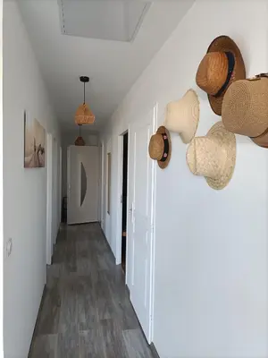 a hallway with hats hanging on the wall at L'hippocampe in Gruissan