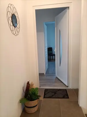 a hallway with a door leading into a room at L'hippocampe in Gruissan