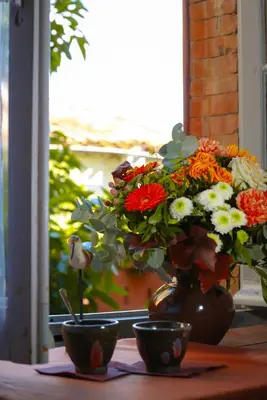 a vase with a bouquet of flowers on a table at Les Chambres des Dames in Rieux-Minervois
