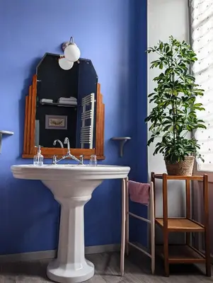 a bathroom with a sink and a large mirror at Les Chambres des Dames in Rieux-Minervois