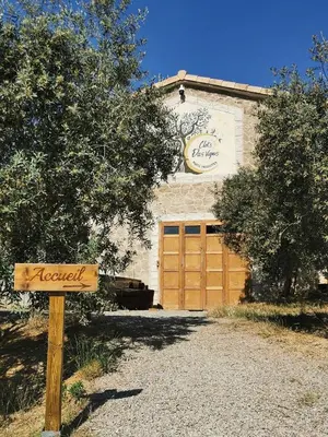 a sign in front of a building with a garage at Le lodge cocooning in Ansignan